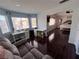 Open bonus room leading to a main bedroom, featuring a desk and ample natural light at 2913 Domino Way, Las Vegas, NV 89117