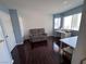 Bonus room with blue accent walls, a comfortable sofa, and a bright window at 2913 Domino Way, Las Vegas, NV 89117