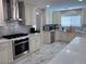 Spacious kitchen with stainless steel appliances, white cabinets, and marble countertops at 2913 Domino Way, Las Vegas, NV 89117