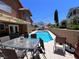 An inviting backyard with a sparkling pool and patio area provides an ideal spot for gatherings and outdoor living at 2913 Domino Way, Las Vegas, NV 89117