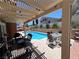 Relaxing backyard pool area with a pergola and outdoor seating provides the perfect space for entertaining or enjoying the sun at 2913 Domino Way, Las Vegas, NV 89117