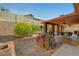 Inviting backyard features covered patio, built-in grill, rock landscaping, and privacy wall at 3071 Misty Moon Ave, Henderson, NV 89052