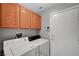 Functional laundry area features modern white appliances and ample above-washer cabinet storage at 3071 Misty Moon Ave, Henderson, NV 89052