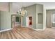 Open-concept living room with archways, built-in shelving, and wood-look floors at 3071 Misty Moon Ave, Henderson, NV 89052