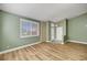 Open-concept room with wood flooring, large window with coverings, and fresh paint at 3071 Misty Moon Ave, Henderson, NV 89052