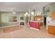 Open-concept living room and kitchen featuring tile floors, decorative lighting, and a cozy fireplace at 3071 Misty Moon Ave, Henderson, NV 89052