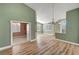 Bright living area with wood-look floors and chandelier lighting at 3071 Misty Moon Ave, Henderson, NV 89052