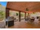 Outdoor kitchen on covered patio complete with BBQ, outdoor dining area, and exposed brick pillars at 3071 Misty Moon Ave, Henderson, NV 89052