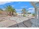 Backyard featuring a rock garden, palm trees, and a covered patio at 3109 Hawksdale Dr, Las Vegas, NV 89134