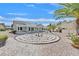 Large backyard features a garden with rock features, desert landscaping and patio cover at 3109 Hawksdale Dr, Las Vegas, NV 89134