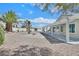 Expansive backyard offers a rock garden, covered patio, desert landscaping, and palm trees at 3109 Hawksdale Dr, Las Vegas, NV 89134