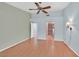 Large bedroom with wood floors, vaulted ceilings, a ceiling fan, sconce lighting, and access to a bathroom at 3109 Hawksdale Dr, Las Vegas, NV 89134