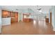 Open-concept living space with wood floors, connecting the living room to the kitchen and dining at 3109 Hawksdale Dr, Las Vegas, NV 89134
