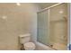 Tiled bathroom featuring a toilet and a glass enclosed shower at 3350 Duece St, Las Vegas, NV 89121