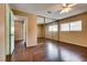 Bedroom with wood floor, closet with mirrored doors, and bright window at 3350 Duece St, Las Vegas, NV 89121
