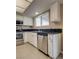 Well-lit kitchen featuring stainless steel dishwasher and black countertops at 3350 Duece St, Las Vegas, NV 89121