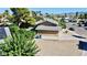 Aerial view of the home with a large gravel yard and mature trees at 3950 Ventura Way, Las Vegas, NV 89121