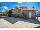 Spacious backyard featuring a stone patio, access stairs, and a neutral toned home exterior at 3950 Ventura Way, Las Vegas, NV 89121