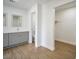 Bathroom with double sinks, gray cabinets, mirrors, and walk in shower at 3950 Ventura Way, Las Vegas, NV 89121