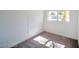 A bright bedroom with neutral carpet, white walls, and natural light streaming through the window at 3950 Ventura Way, Las Vegas, NV 89121