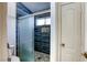 Modern bathroom design featuring dark tile accents and glass enclosed shower at 40 Trailside Ct, Henderson, NV 89012