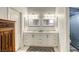 Bathroom with a double sink vanity, sleek fixtures, and a glass-door shower at 40 Trailside Ct, Henderson, NV 89012