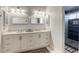 Bright bathroom featuring a double sink vanity, modern lighting, and a glass-door shower at 40 Trailside Ct, Henderson, NV 89012