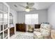 Bright bedroom featuring light walls, a charming ceiling fan, and a cozy floral armchair at 40 Trailside Ct, Henderson, NV 89012