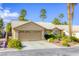 Charming home with well-manicured landscaping, a two-car garage, and mature palm trees at 40 Trailside Ct, Henderson, NV 89012