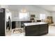 Beautiful kitchen with white cabinets, stainless steel appliances, and a central island with a marble countertop at 40 Trailside Ct, Henderson, NV 89012