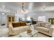 Open-concept layout of the living room, kitchen, and dining area; features contemporary furnishings and lighting at 40 Trailside Ct, Henderson, NV 89012