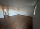 Empty living room features light wood flooring and crisp white walls at 4300 N Lamont St # 225, Las Vegas, NV 89115