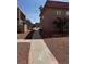 A community walkway showing the exterior of multiple residences on a sunny day at 4300 N Lamont St # 225, Las Vegas, NV 89115