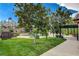 Landscaped backyard with ample green space, mature trees, and an outdoor dining area, perfect for entertaining at 4617 Gonzales Dr, Las Vegas, NV 89130