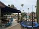 Expansive backyard with covered patio, outdoor dining, pool, trampoline, and play set at 4617 Gonzales Dr, Las Vegas, NV 89130