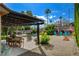 Lovely outdoor living space with pergola, dining table, fire pit, and refreshing pool at 4617 Gonzales Dr, Las Vegas, NV 89130