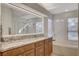 Bright bathroom with double sink vanity, granite counters, and a separate tub and shower at 4617 Gonzales Dr, Las Vegas, NV 89130