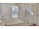 Bright bathroom featuring a walk-in glass shower and a soaking tub by the window at 4617 Gonzales Dr, Las Vegas, NV 89130