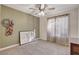 Cozy bedroom featuring neutral tones, plush carpet, and soft natural light through sheer curtains at 4617 Gonzales Dr, Las Vegas, NV 89130