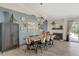 Dining room with table for eight, modern light fixture, and statement wall decor at 4617 Gonzales Dr, Las Vegas, NV 89130