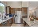 Bright kitchen featuring stainless steel appliances, granite countertops, and dark wood cabinetry at 4617 Gonzales Dr, Las Vegas, NV 89130