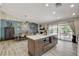 Open-concept living room and kitchen area with an island, wood floors, and access to a patio and pool at 4617 Gonzales Dr, Las Vegas, NV 89130