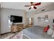 Cozy main bedroom featuring a ceiling fan, TV, and wood-look flooring at 4617 Gonzales Dr, Las Vegas, NV 89130