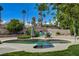 Beautiful kidney-shaped pool and backyard with lush landscaping, lounge chairs, and desert plants at 4617 Gonzales Dr, Las Vegas, NV 89130
