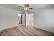 Bright bedroom featuring wood-look floors, a ceiling fan, and access to an en-suite bathroom at 4855 S Torrey Pines Dr # 101, Las Vegas, NV 89103