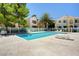 Relaxing community pool surrounded by palm trees, lounge chairs, and lush landscaping at 4855 S Torrey Pines Dr # 101, Las Vegas, NV 89103