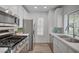 Well-appointed kitchen with stainless appliances, stone counters, and ample natural light at 4855 S Torrey Pines Dr # 101, Las Vegas, NV 89103