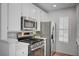 Modern kitchen with stainless steel appliances and white cabinetry at 4855 S Torrey Pines Dr # 101, Las Vegas, NV 89103