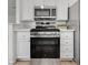 Well-equipped kitchen featuring stainless steel appliances and sleek white cabinetry at 4855 S Torrey Pines Dr # 101, Las Vegas, NV 89103