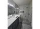 Bathroom featuring a walk-in shower with designer tile and a vessel sink at 5155 W Tropicana Ave # 2089, Las Vegas, NV 89103